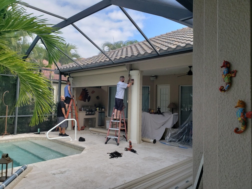Technician performing hurricane shutter service